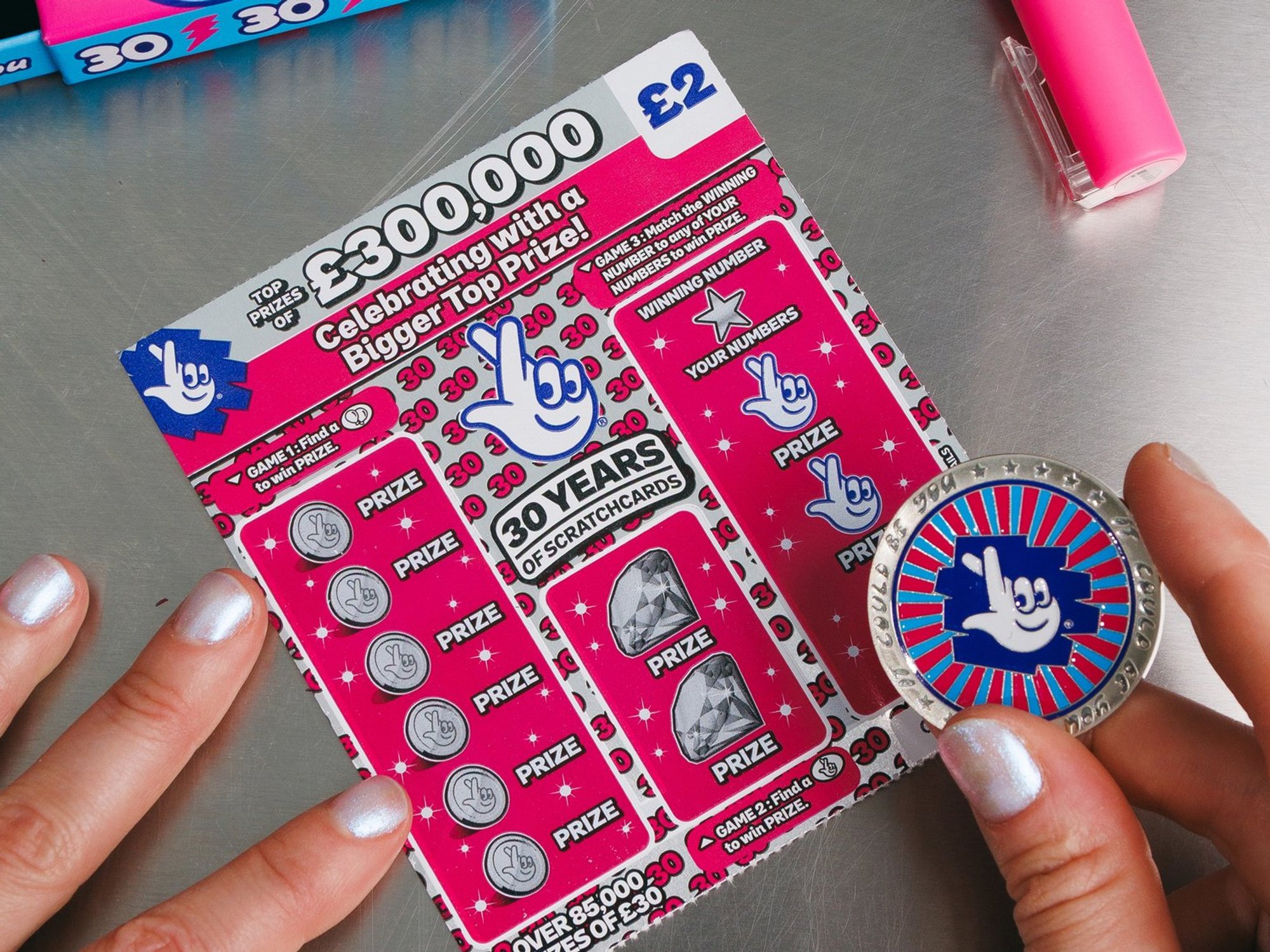 The National Lottery coin and a scratchcard