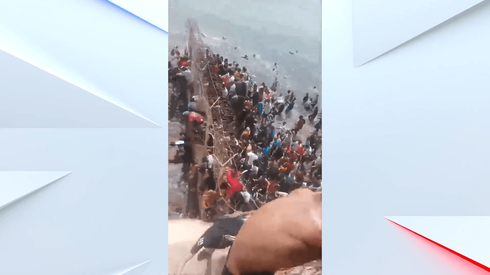 Thousands of people climbing the border fence in Ceuta