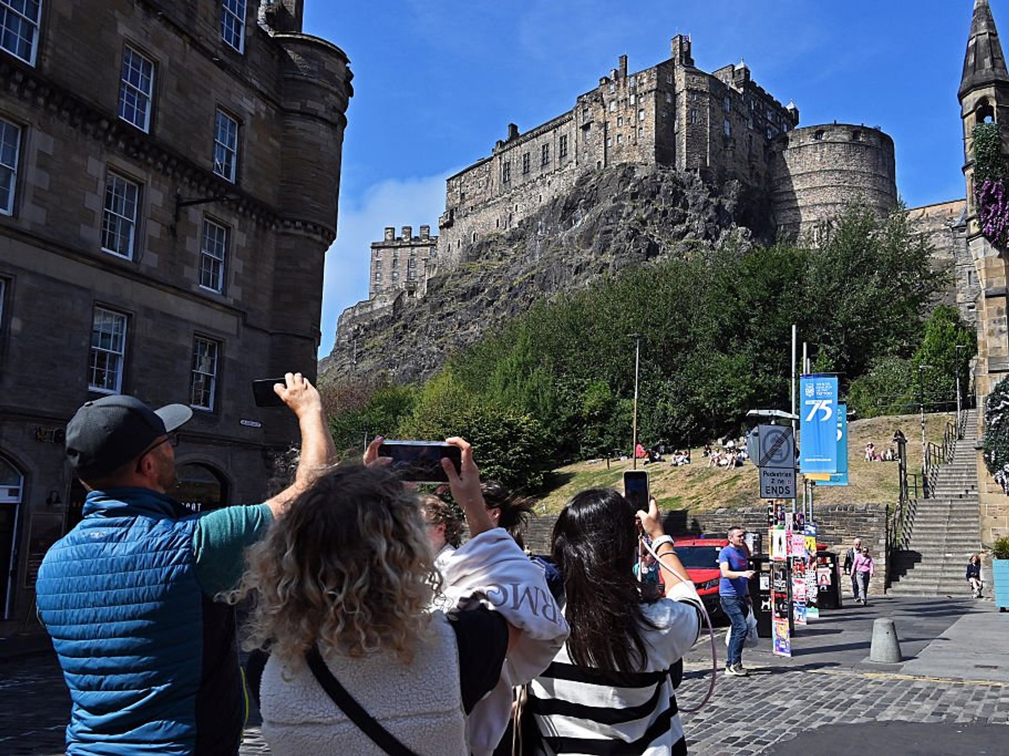 Tourists taking pictures of the Edinburgh Castle during the Edinburgh Festival Fringe