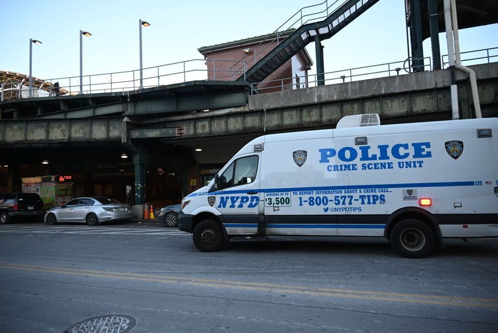 \u200b Police investigates the scene where a woman died after being lit on fire by a man aboard an MTA subway train