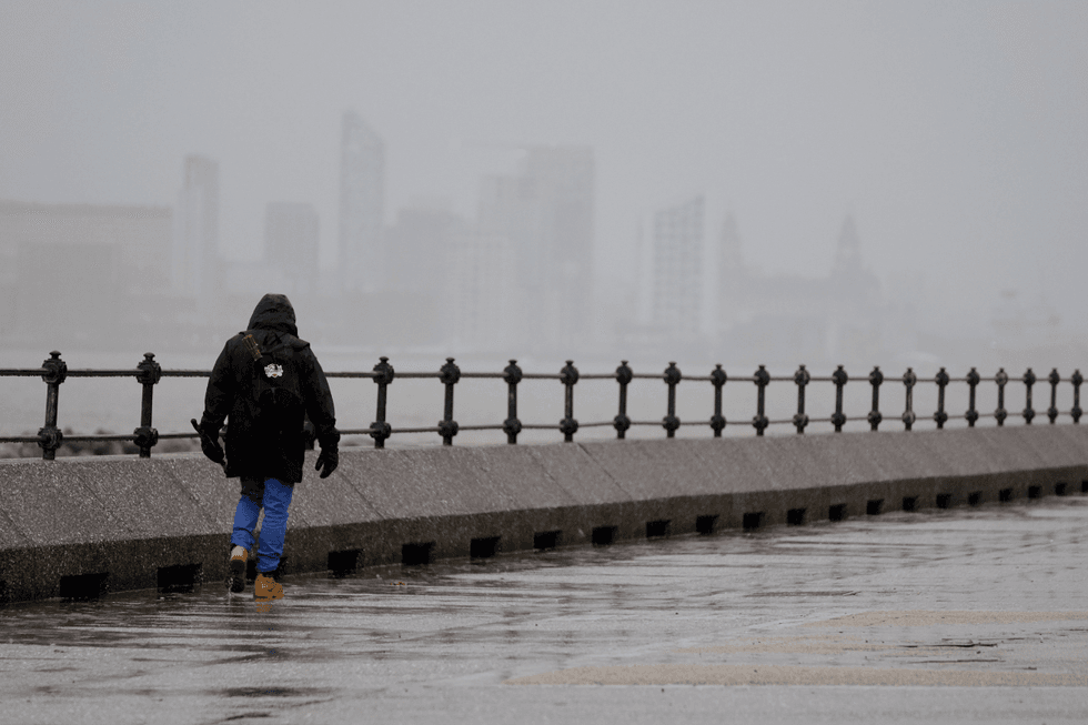 \u200bA man walks along The Promenade New Brighton in Liverpool
