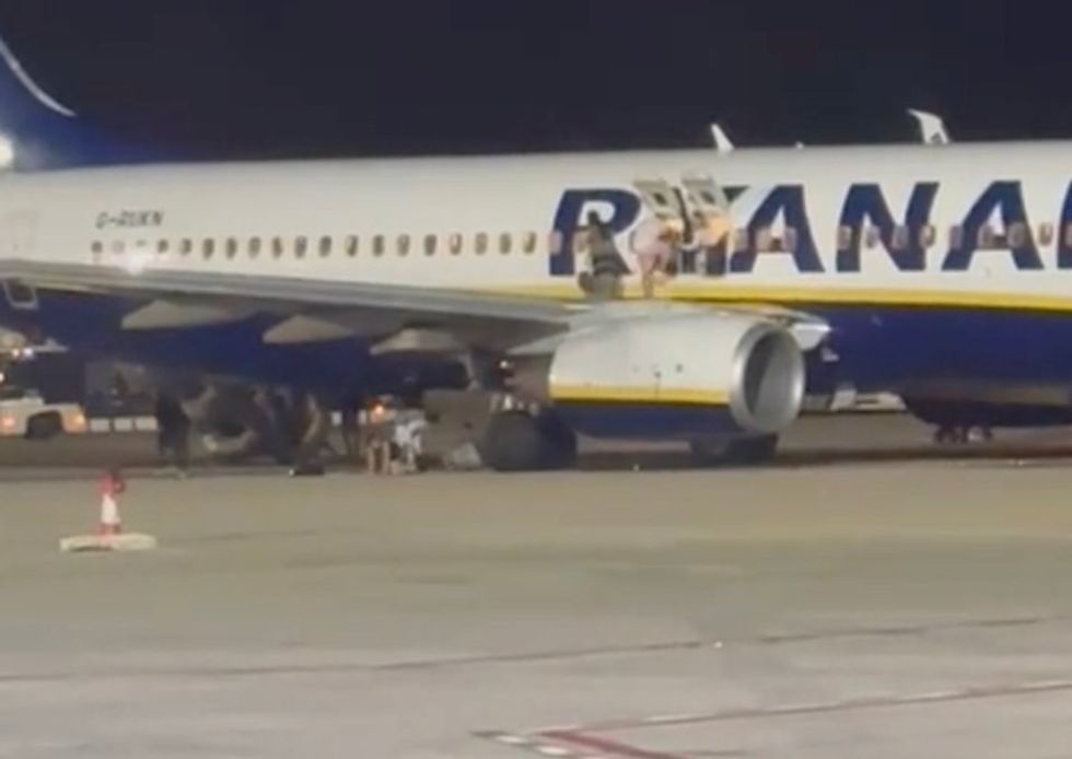 \u200bA passenger can be seen exiting the plane onto its wing