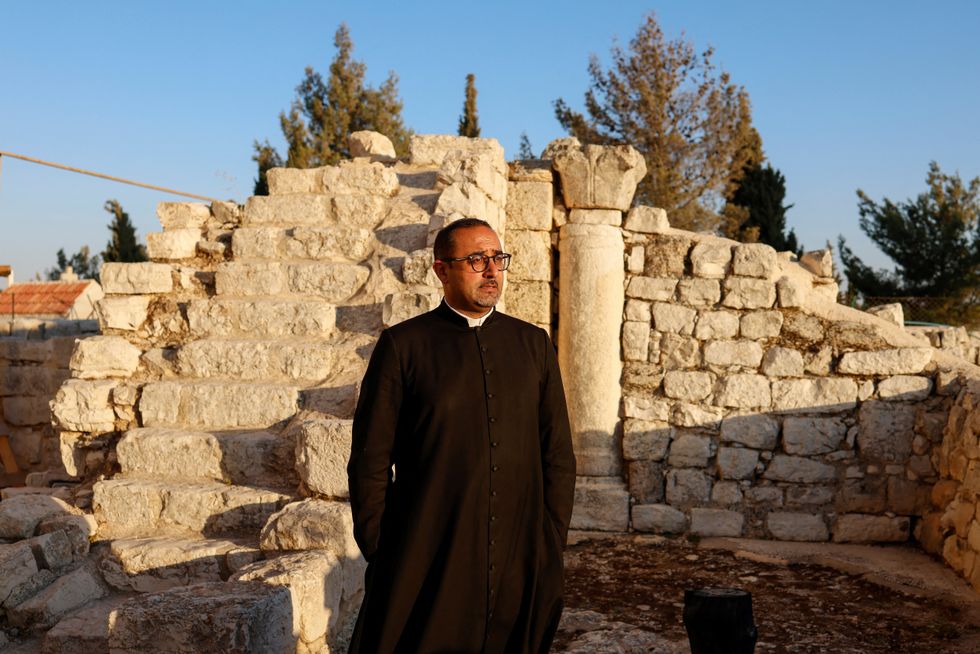 \u200bFather Bashar Fawadleh inside the Old Church of St George in Taybeh