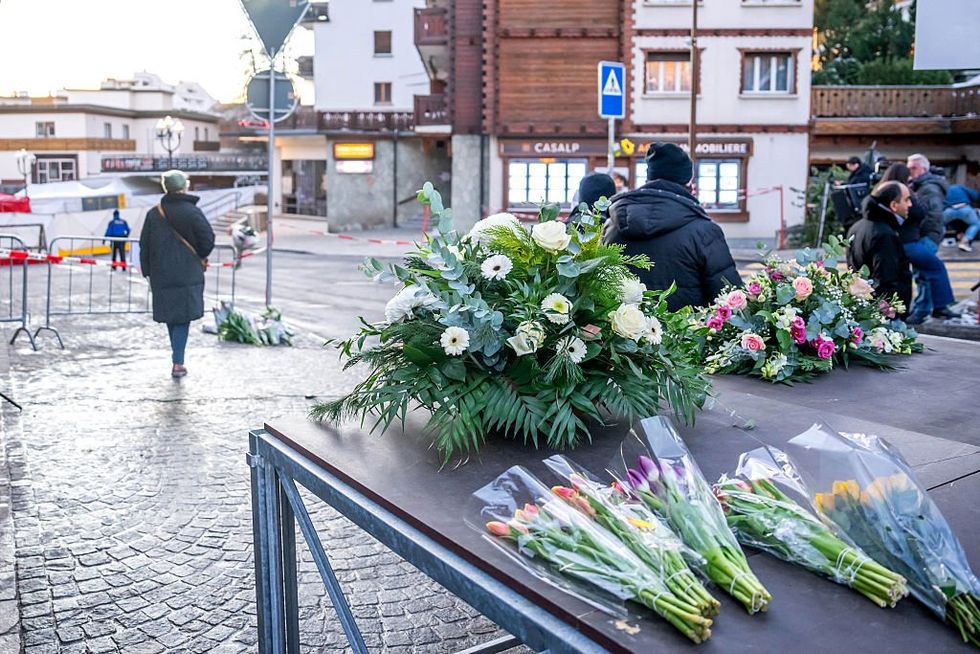\u200bFlowers are laid near the site