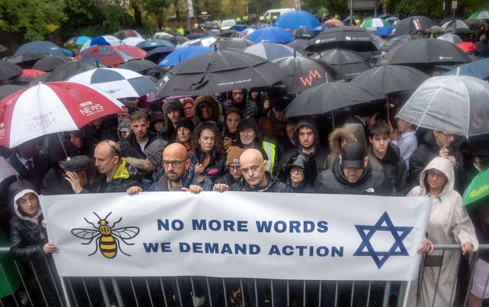 \u200bLocals held up a banner reading 'No more words, we demand action' at the terror attacks vigil