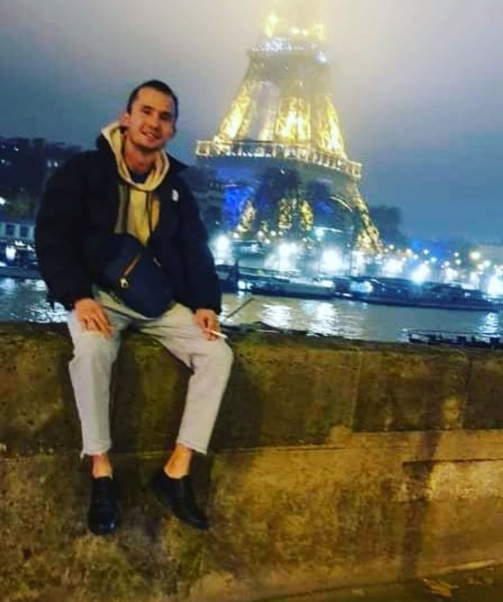 \u200bNikzad posing by the Eiffel Tower in Paris