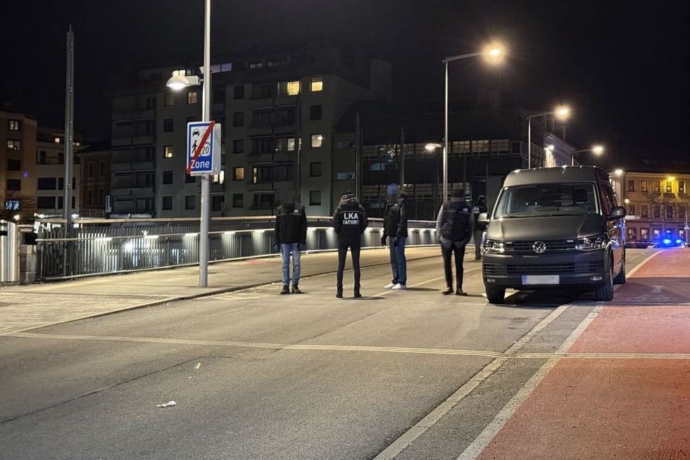 \u200bOfficers of the Austrian State Criminal Police are seen near a cordoned off area after a knife attack near the main square in the city centre of Villach