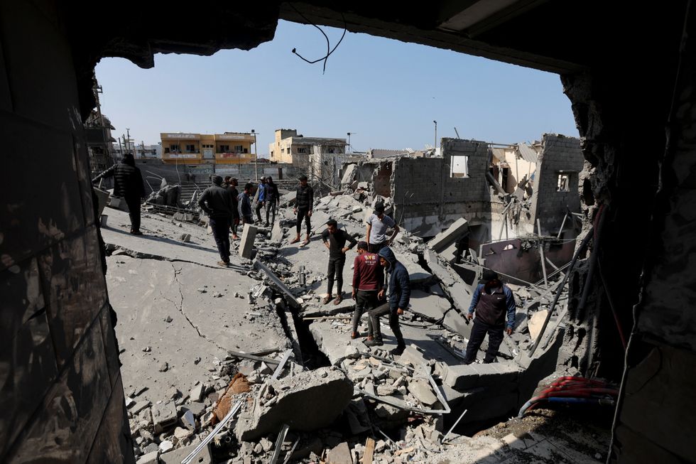\u200bPalestinians inspect the site of an Israeli strike on a residential building, in Deir Al-Balah in the central Gaza Strip