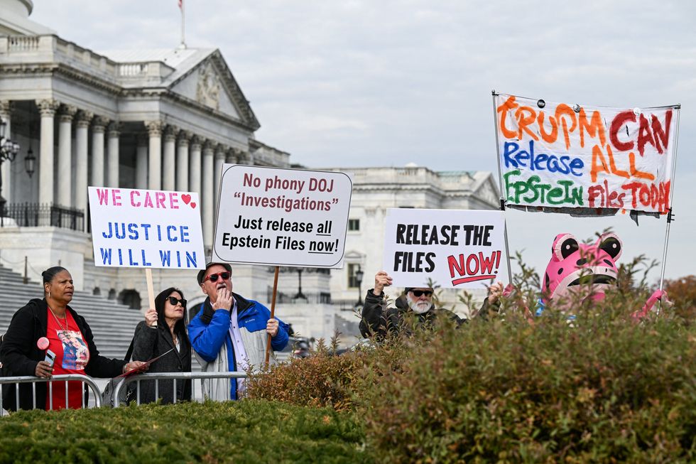 \u200bProtesters stand behind the barricades