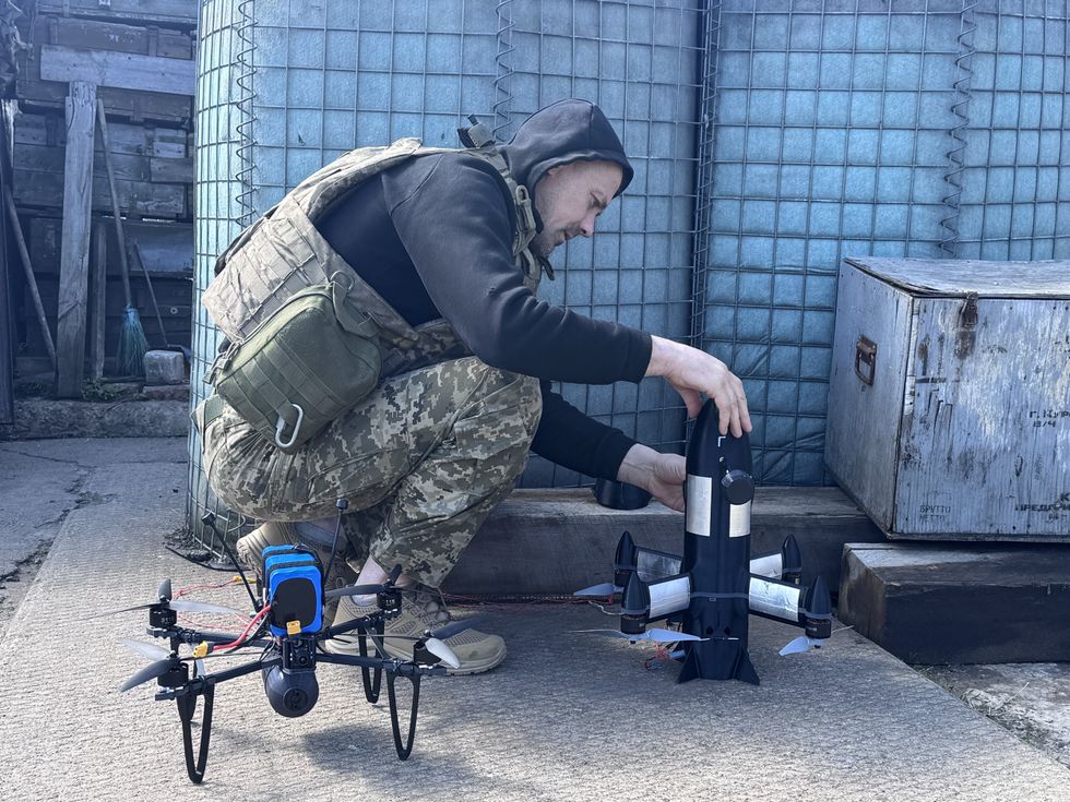 Ukrainian soldier arming combat drones