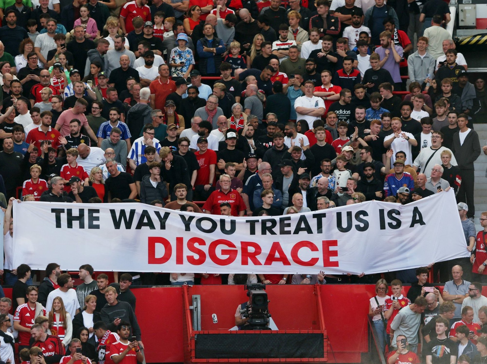 United fans held a banner reading: 'The way you treat us is a disgrace'
