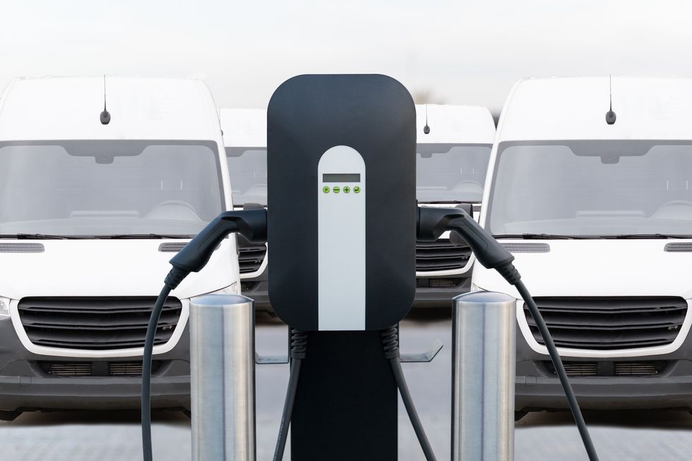 Vans charging at an electric charger point