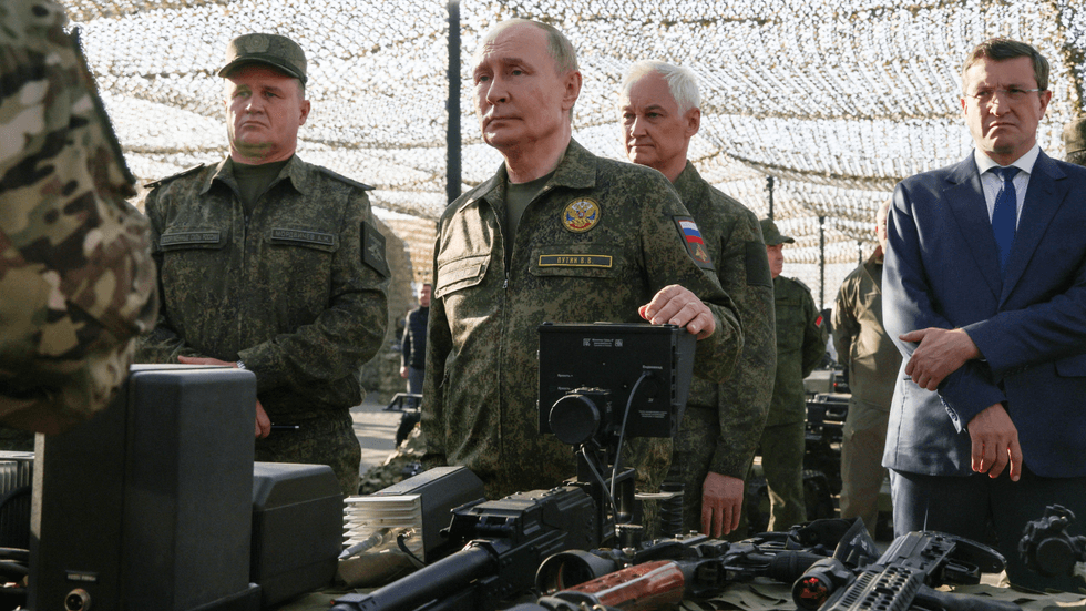 Vladimir Putin inspecting military equipment