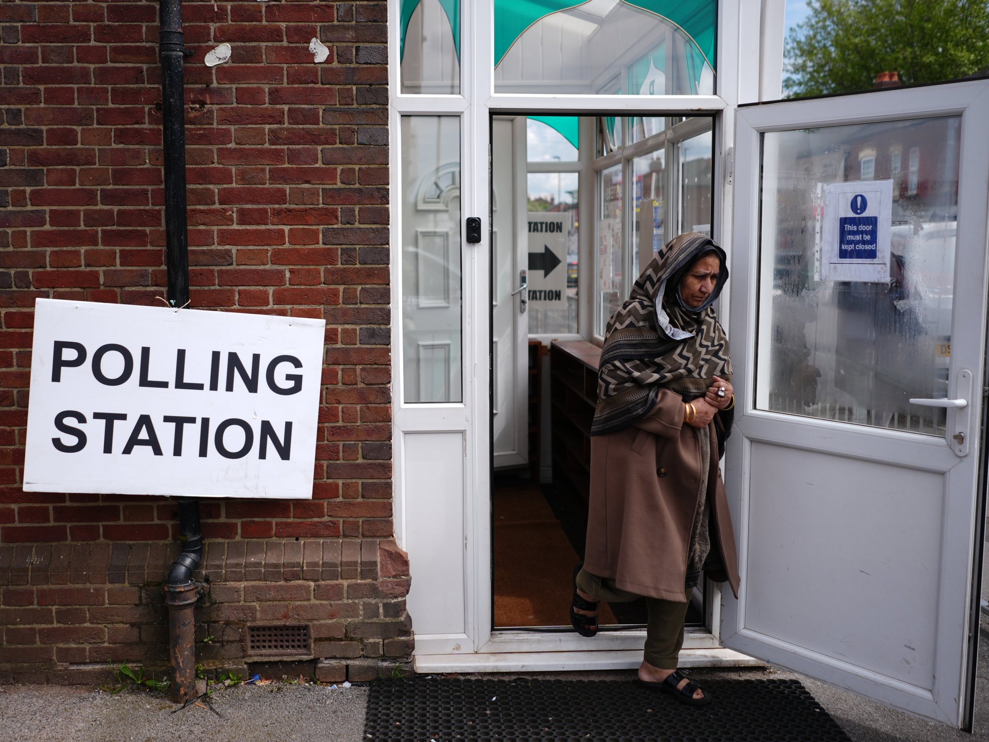 Voter leaving a poll station on Green Lane in Small Heath, Birmingham as part of the May local elections