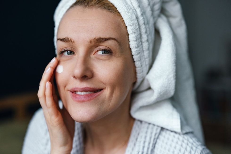 Woman applying eye cream