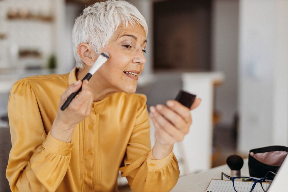 woman applying makeup