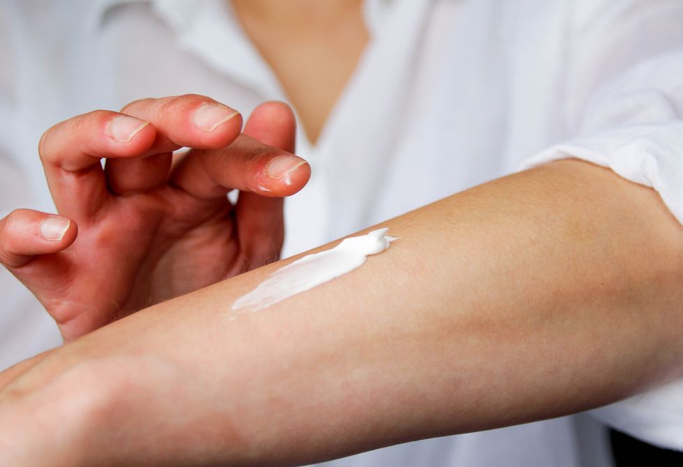 Woman applying sunscreen to her arm