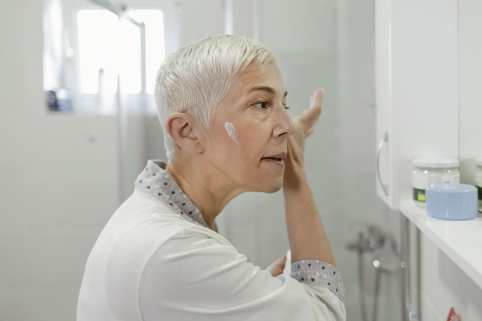 Woman applying sunscreen