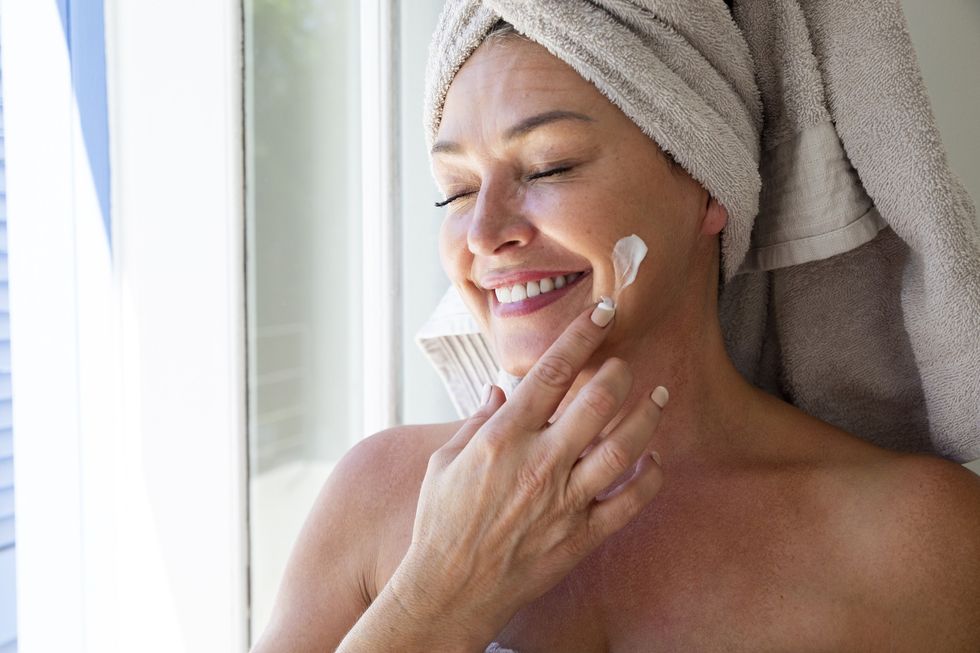 Woman applying sunscreen