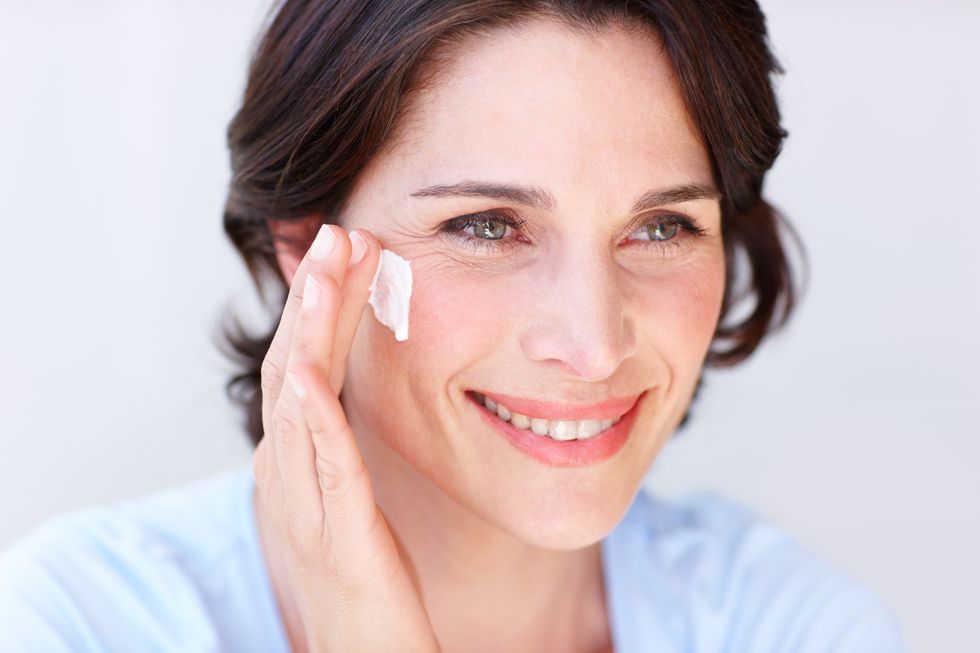 Woman applying sunscreen