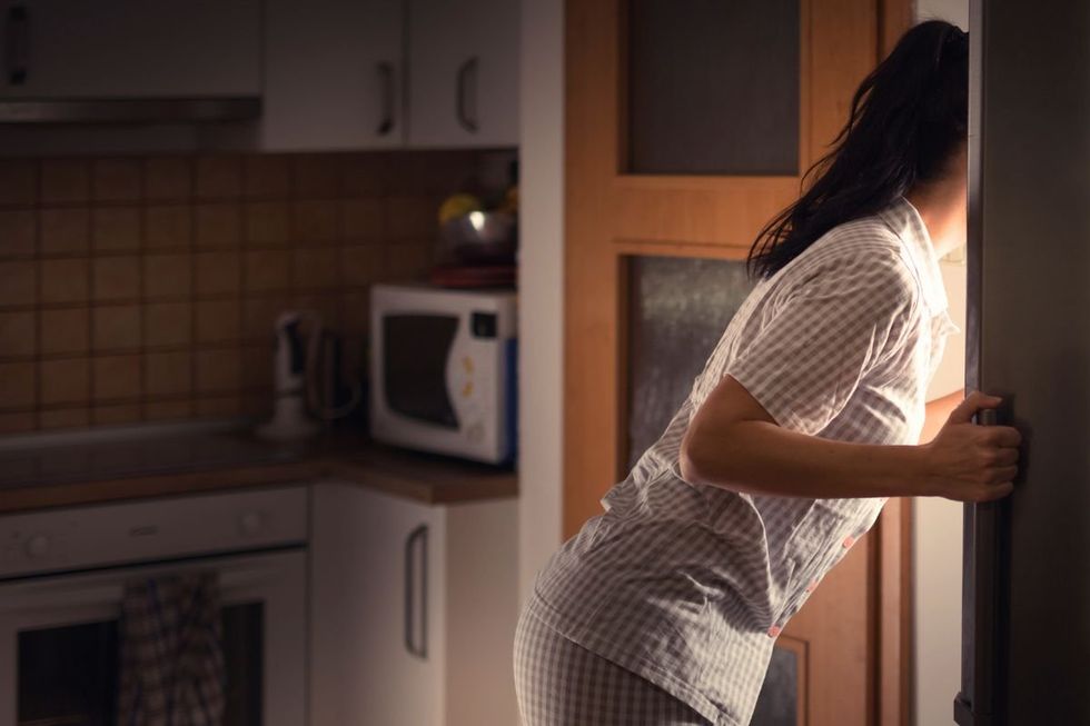 WOMAN CHECKING FRIDGE