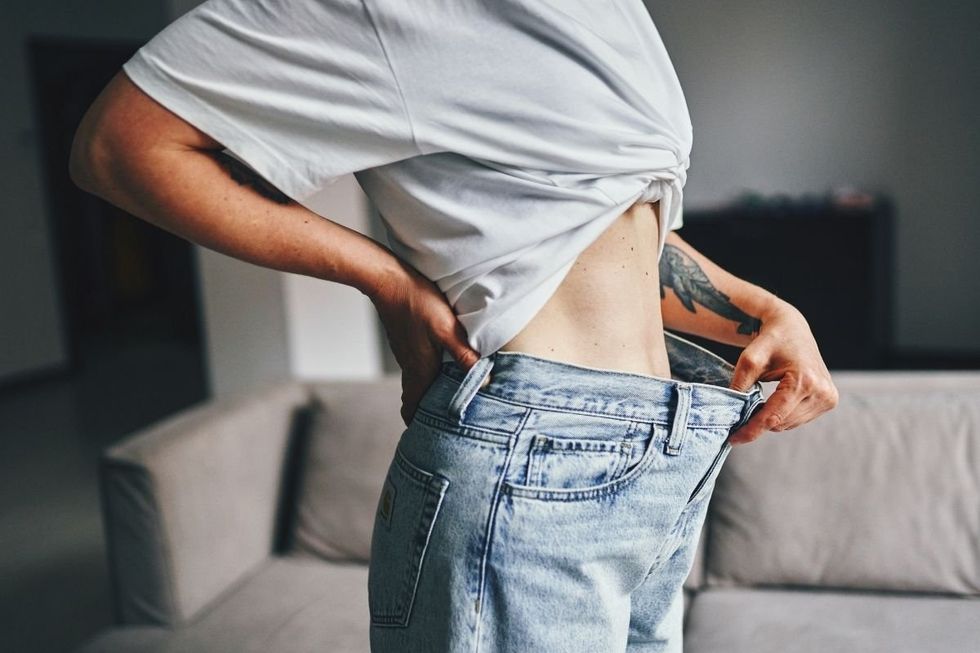 WOMAN CHECKING WAIST