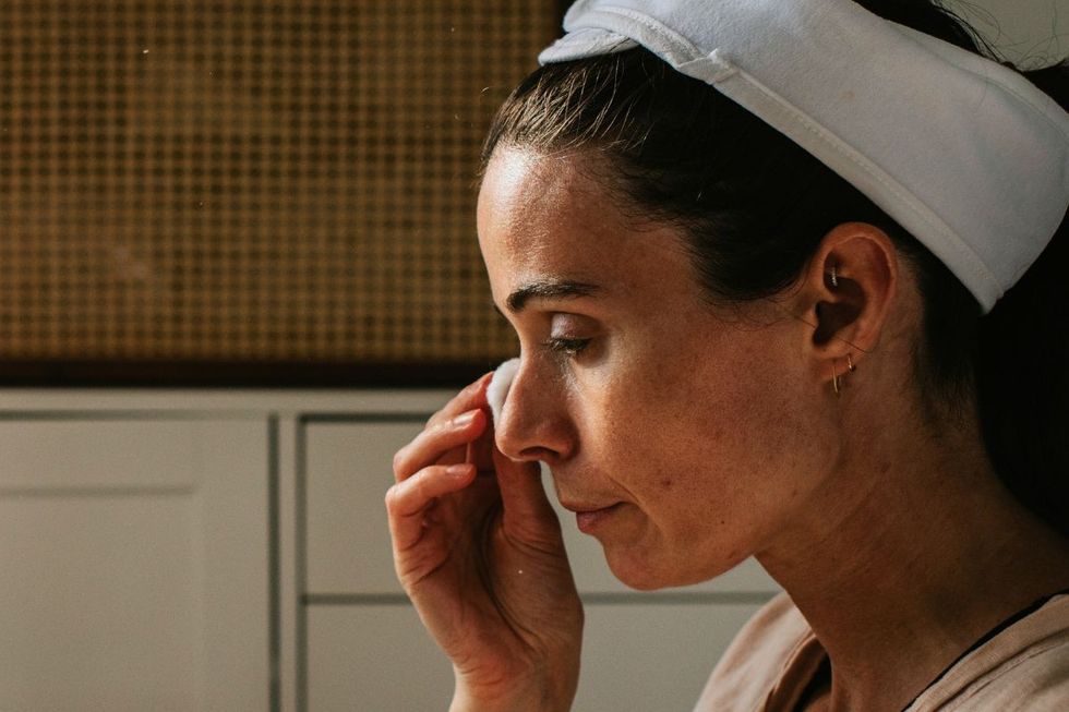 Woman cleansing face