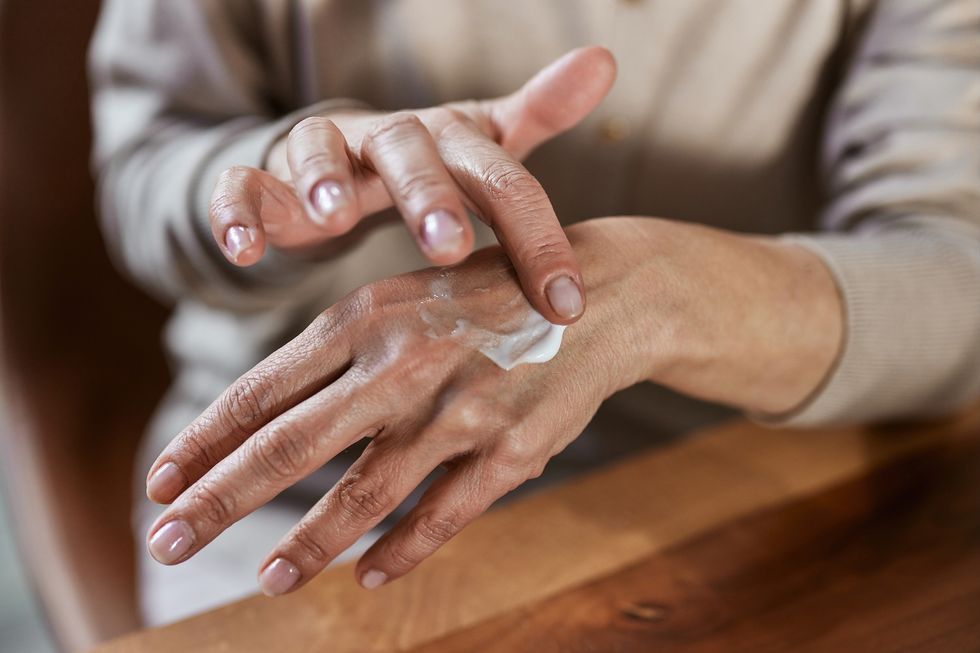 Woman cream on hand