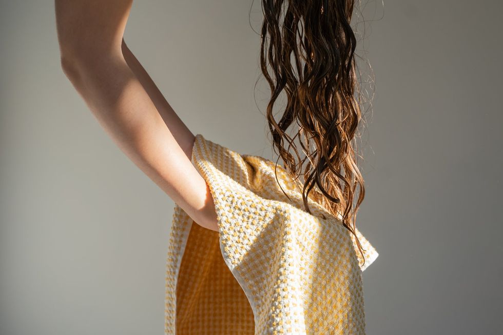 WOMAN DRYING HAIR