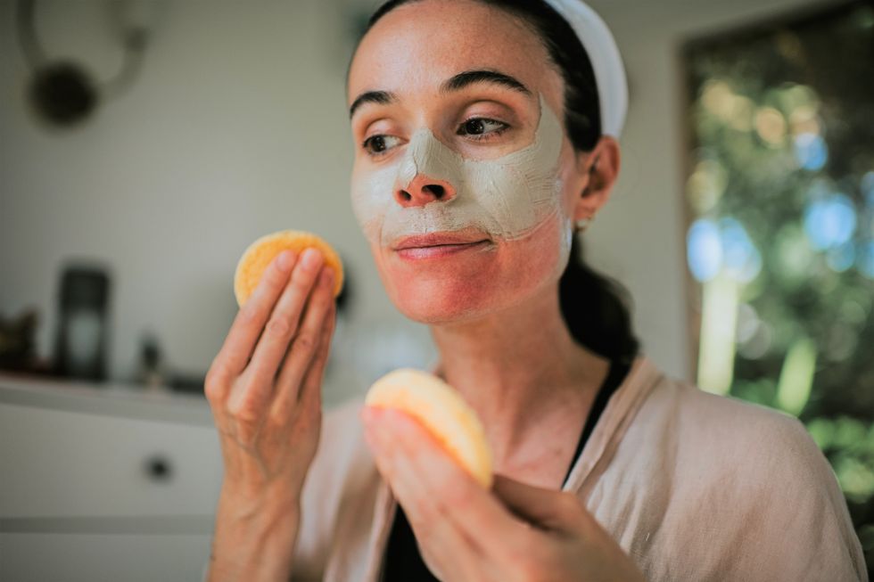 Woman exfoliating her face