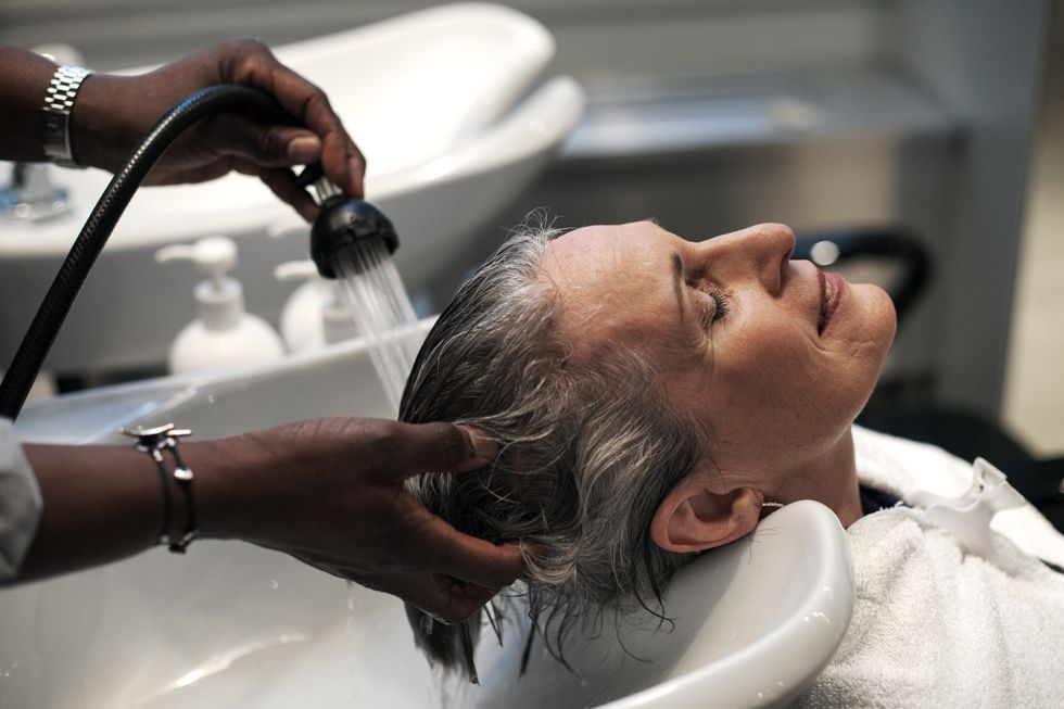 WOMAN HAVING HAIR WASHED