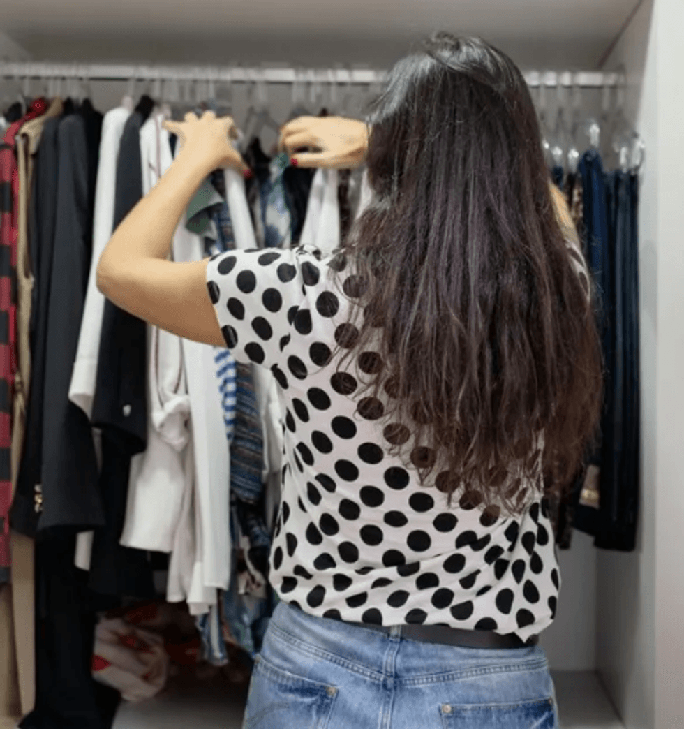 Woman looking through clothing rail