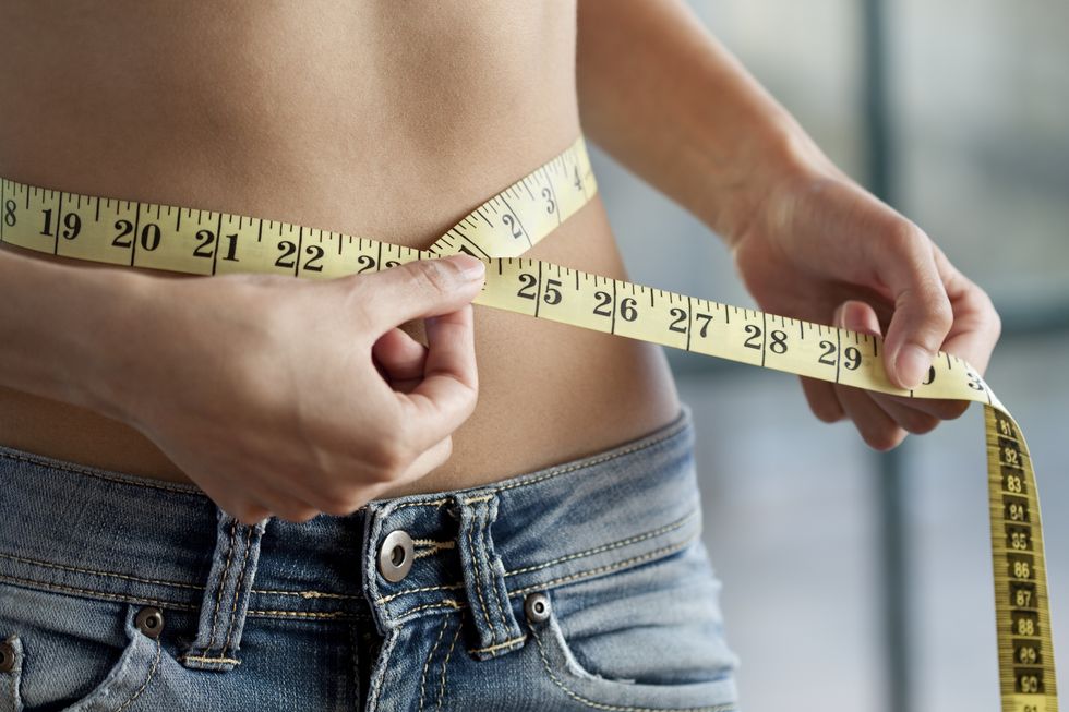 woman measuring waist