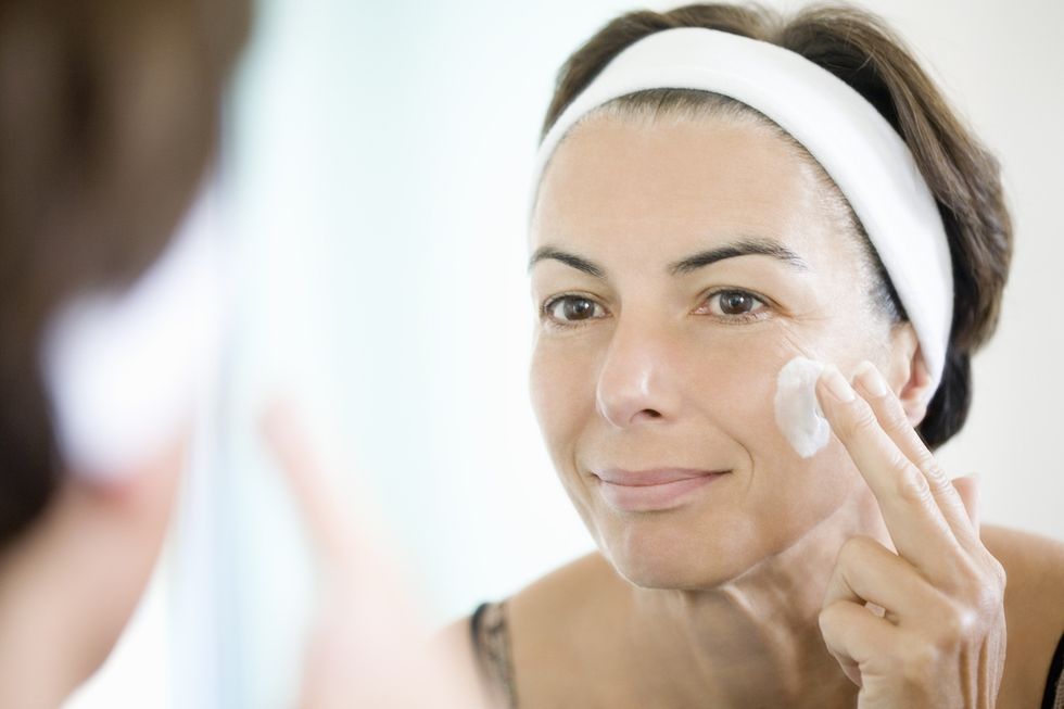 Woman moisturising her face