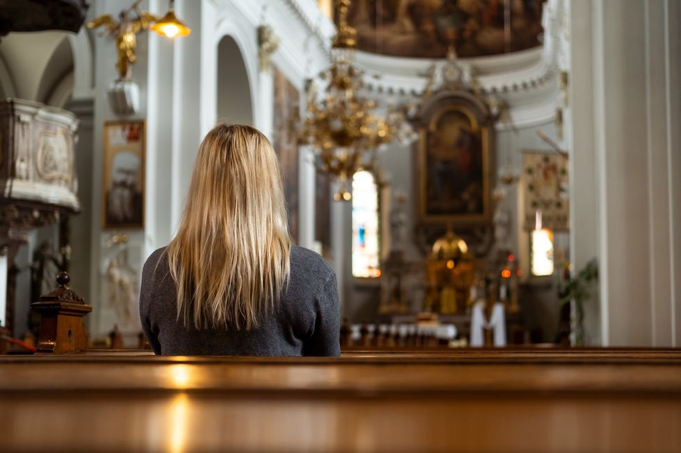 Woman praying in a Church