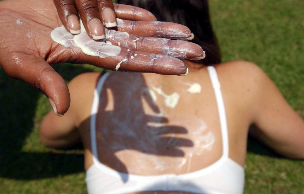 Woman putting on SPF