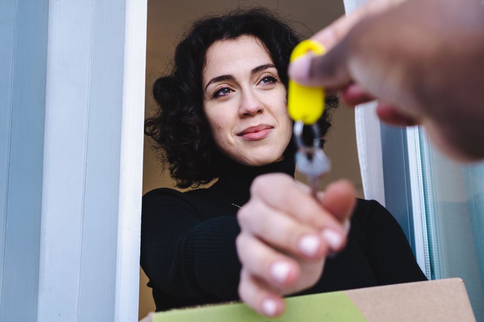WOMAN REACHING FOR KEY
