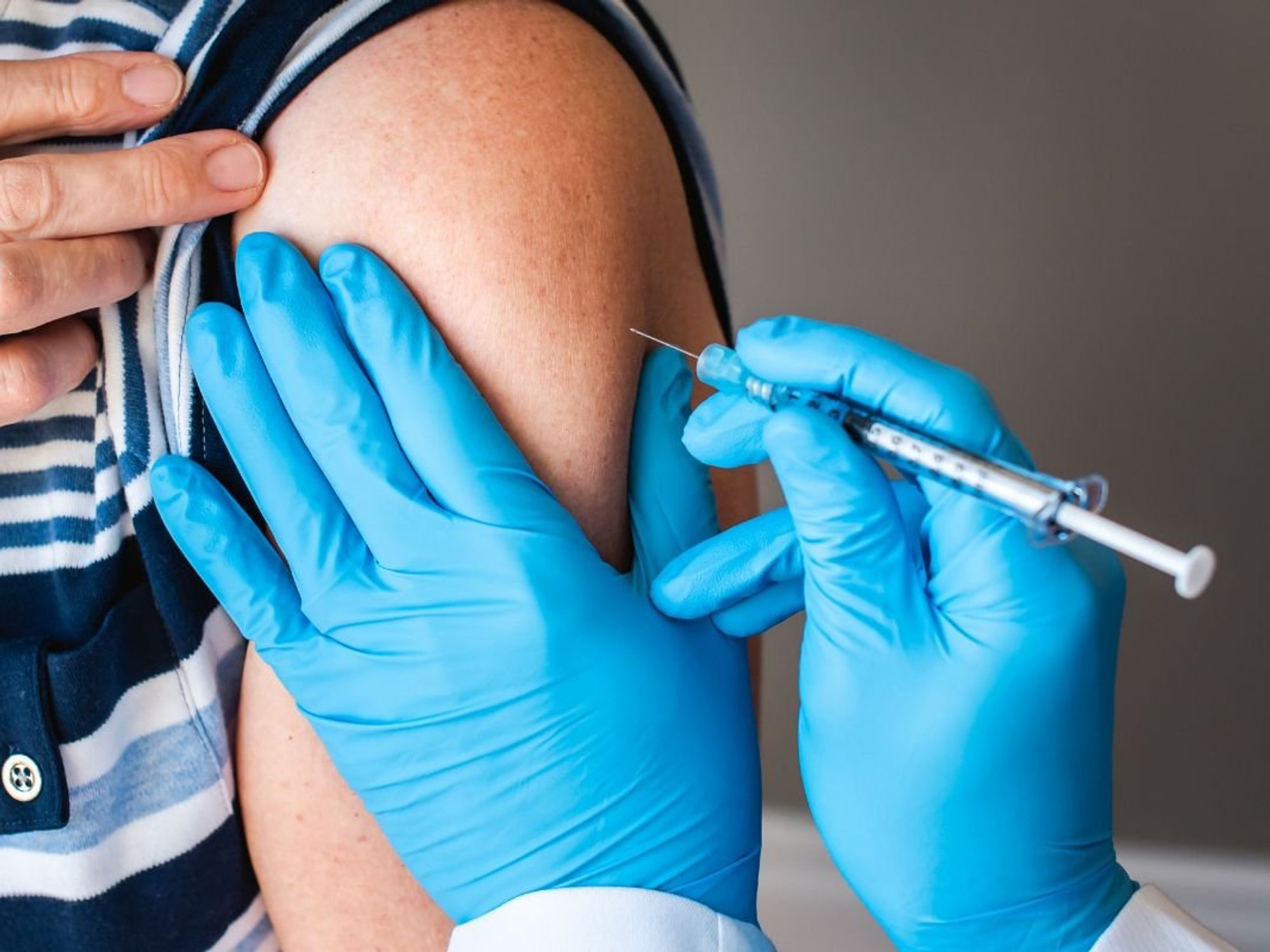 WOMAN RECEIVING VACCINATION