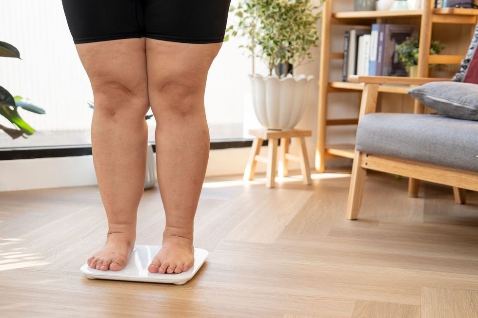 WOMAN STANDING ON SCALE