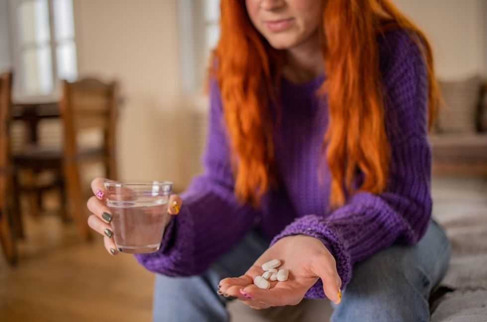 Woman taking supplement