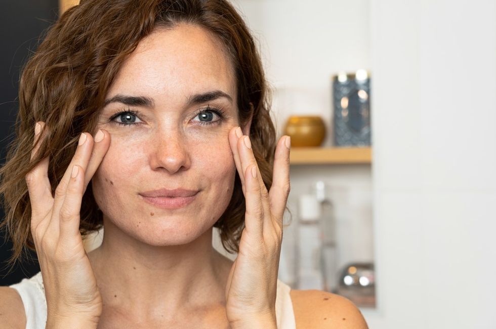 Woman touching face doing her skin care