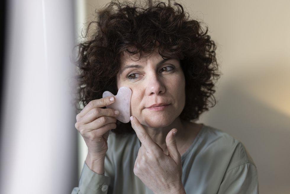 Woman using gua sha tool