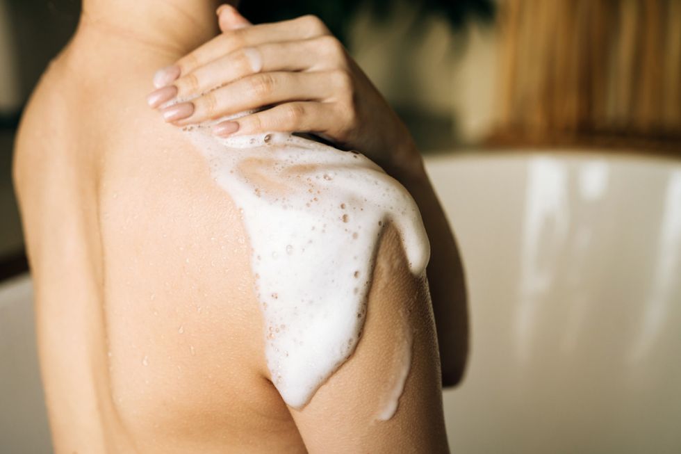 Woman using shower gel