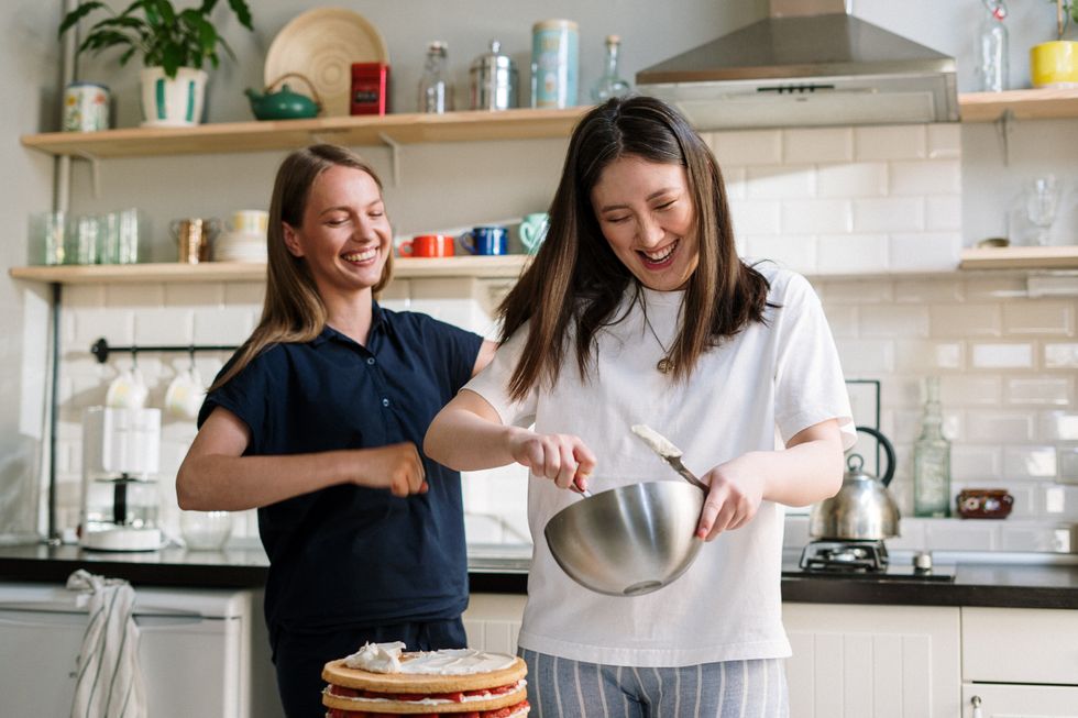 Women baking cake at home