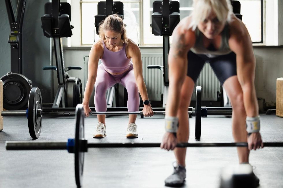 WOMEN LIFTING WEIGHTS