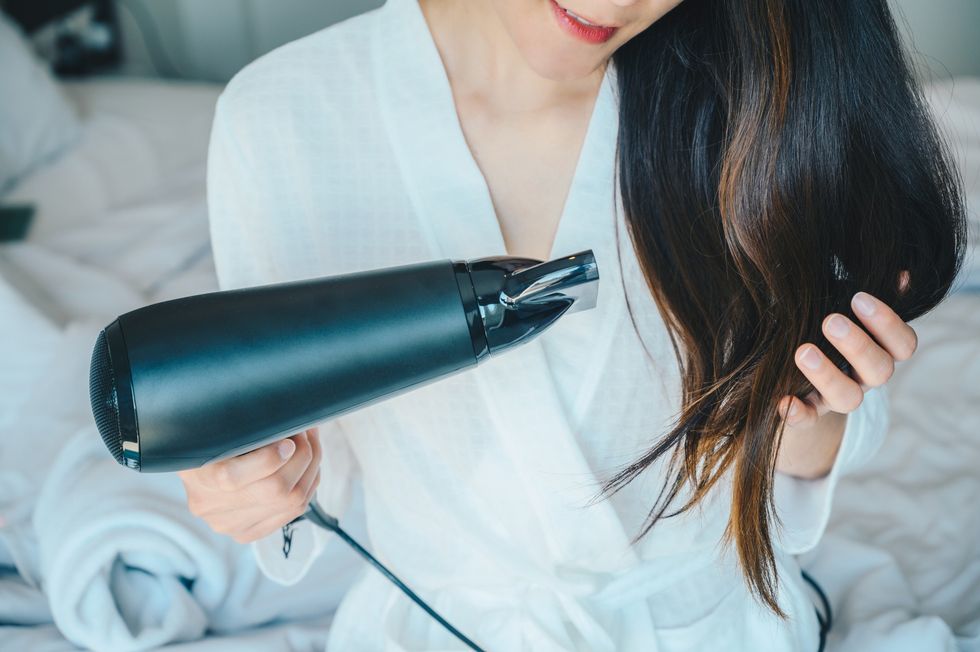 Womna blowdrying her hair